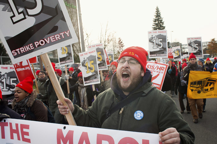 Aaron Sherman yells slogans in SeaTac, Washington during a protest march from SeaTac to Seattle aimed at the fast food industry and raising the federal minimum wage and Seattle's minimum wage to $15 an hour December 5, 2013. (Reuters/David Ryder)