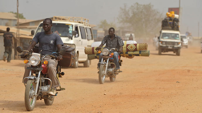 Residents of Juba with their belongings ride out of the city on December 21, 2013 where tension remains high fueling an exodus of both local and foreign residents from the south Sudanese capital.(AFP Photo / Tony Karumba)