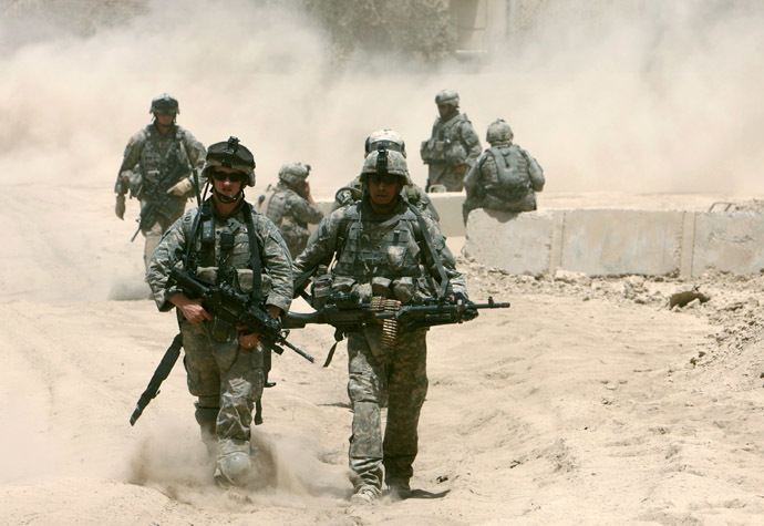 U.S. soldiers walk through dust in front of their base after a patrol in Baquba June 26, 2007. (Reuters) 