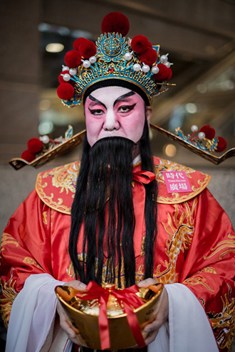 A man wears a traditional costume during an event celebrating the upcoming Year of the Horse, outside a shopping mall in Hong Kong. (AFP Photo / Philippe Lopez)