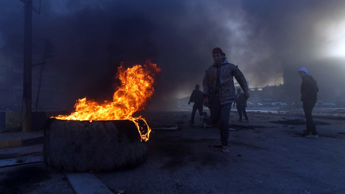 Protestors block a street with burning tyres in Libya's second city of Benghazi on February 26, 2014 after the killings of two policemen.(AFP Photo / Abdullah Doma)