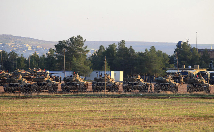 Tanks are positioned at a military base on the Turkish-Syrian border (Reuters)
