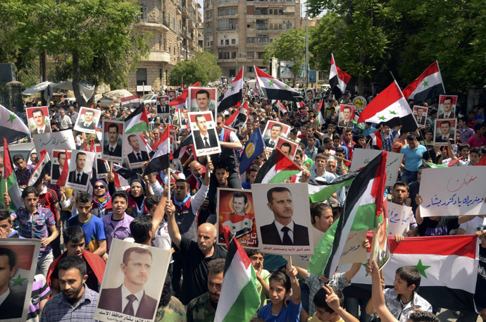 Supporters of Syria's President Bashar al-Assad take part in a rally showing support a day after he declared that he would seek re-election in June, in Aleppo April 29, 2014. (Reuters)