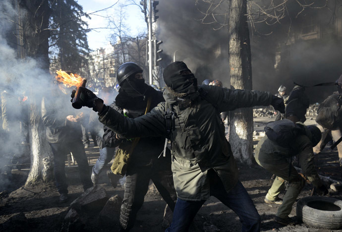 An anti-government protester throws a Molotov cocktail towards Interior Ministry members during clashes in Kiev, February 18, 2014. (Reuters/Maks Levin)