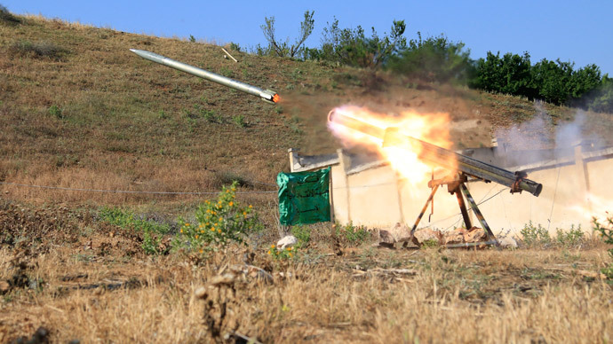 A missile is fired by Free Syrian Army fighters towards forces loyal to Syria's President Bashar al-Assad in the eastern Hama countryside May 14, 2014.(Reuters / Mohamad Bayoush)