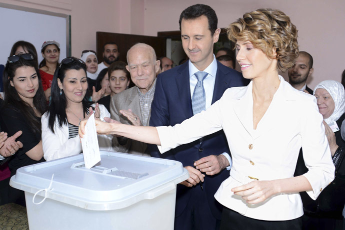 Syria's President Bashar al-Assad and his wife Asma cast their votes in the country's presidential elections at a polling station in Damascus June 3, 2014, in this handout released by Syria's national news agency SANA. (Reuters/SANA)