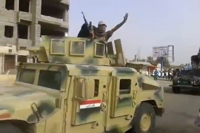 Militants from the Islamic State of Iraq and the Levant (ISIL) parading with an Iraqi army vehicle in the northern city of Baiji in the in Salaheddin province. (AFP Photo / HO / Youtube)