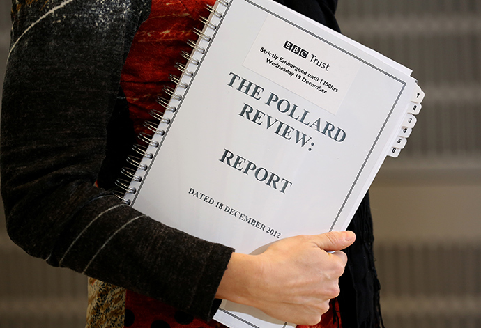A journalist holds a copy of the Pollard Report into the BBC's handling of the child-sex abuse claims against late presenter Jimmy Savile upon the reports publication at BBC Broadcasting House in London on December 19, 2012 (AFP Photo)