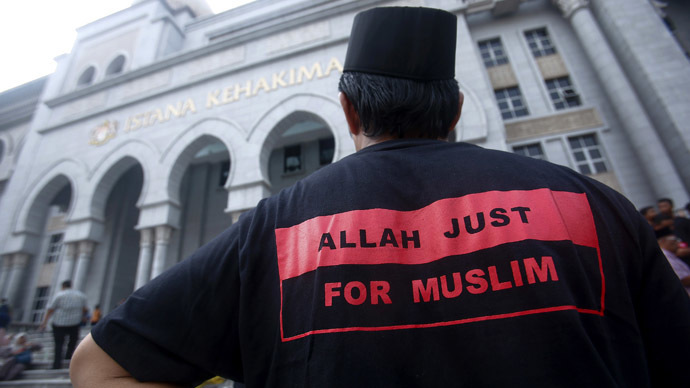 A Muslim man stands outside the court in Putrajaya outside Kuala Lumpur June 23, 2014. (Reuters/Samsul Said)