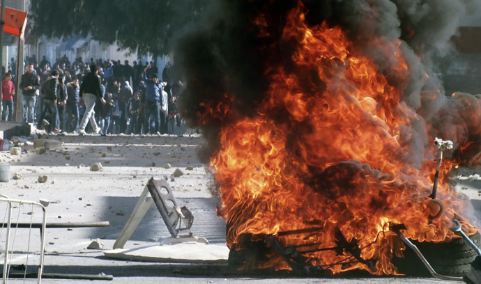 Tyres set on fire by protesters burn during clashes with police in Kasserine January 8, 2014. (Reuters)