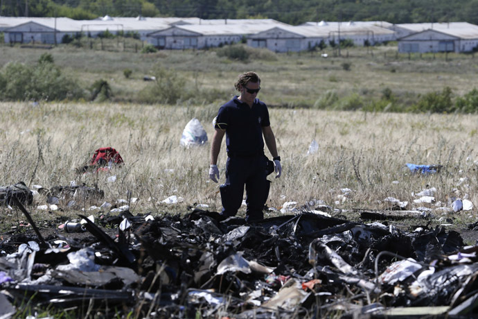 A member of a group of international experts inspects the site where the downed Malaysia Airlines flight MH17 crashed, near the village of Hrabove (Grabovo) in Donetsk region, eastern Ukraine August 1, 2014. (Reuters)