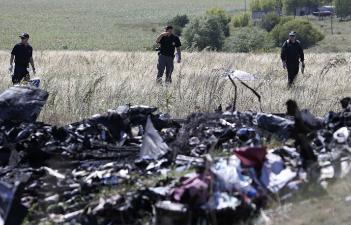 A group of international experts, including members of the Dutch police mission, work at the site where the downed Malaysia Airlines flight MH17 crashed, near the village of Hrabove (Grabovo) in Donetsk region, eastern Ukraine August 1, 2014. (Reuters/Sergei Karpukhin)