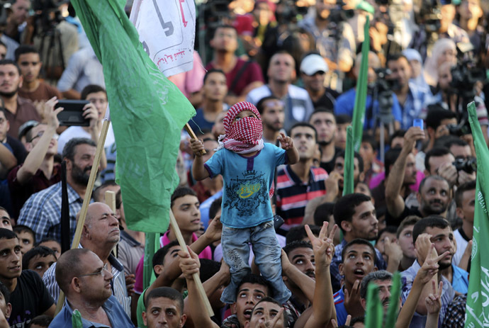 Palestinians Hamas supporters celebrate with people what they said was a victory over Israel, in Gaza City August 27, 2014. (Reuters)