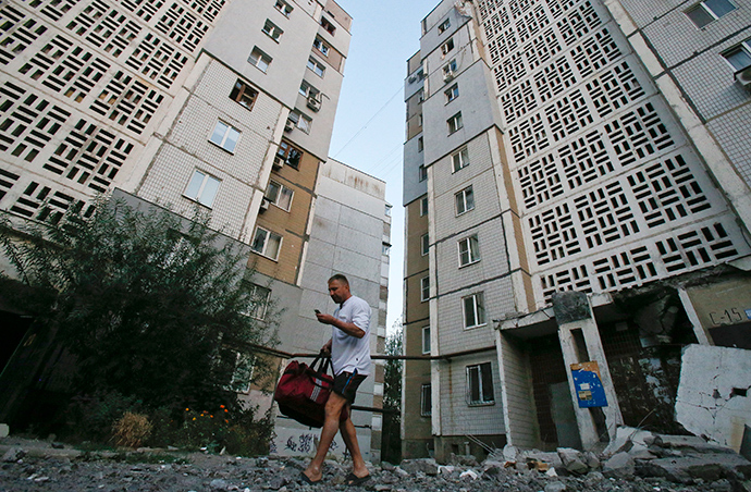 A man walks on rubble near an apartment block damaged by what locals say was shelling by Ukrainian forces in Donetsk, September 4, 2014 (Reuters / Maxim Shemetov)