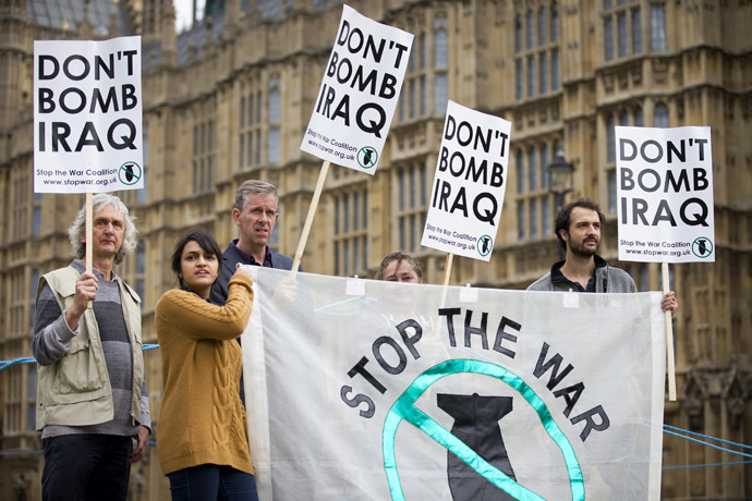 Protesters hold placards which read "Don't Bomb Iraq" outside the Houses of Parliament where lawmakers are expected to vote in favour of joining air strikes against Islamic State (IS) militants in central London on 26 September, 2014. (AFP Photo)