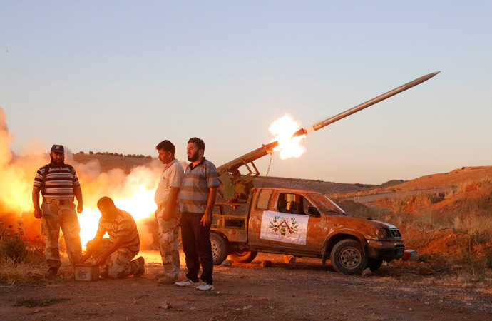 Free Syrian Army fighters launch a rocket towards Hama military airport that is controlled by forces loyal to Syria's President Bashar al-Assad, in the Hama countryside July 25, 2014. (Reuters / Badi Khlif)