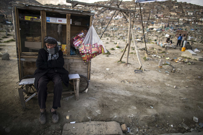 A street vendor waits for customers near a cemetery in Kabul. (Reuters/Zohra Bensemra)