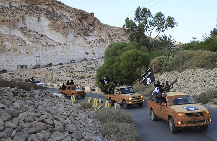 An armed motorcade belonging to members of Derna's Islamic Youth Council, consisting of former members of militias from the town of Derna, drive along a road in Derna, eastern Libya October 3, 2014. (Reuters/Stringer)