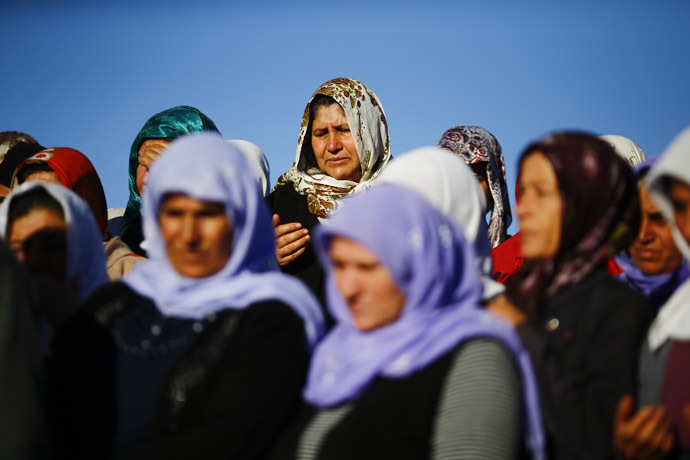 Turkish Kurdish women mourn during the funeral of Kurdish fighters killed during clashes against Islamic State in Kobani, at a cemetery in the southeastern town of Suruc, Sanliurfa province October 21, 2014. (Reuters/Kai Pfaffenbach)