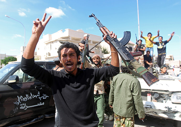 Libyan National Transitional Council (NTC) fighters celebrate in the eastern coastal city of Sirte following news of Moamer Kahdafi's capture and death on October 20, 2011.(AFP Photo/Ahmad Al-Rubaye)