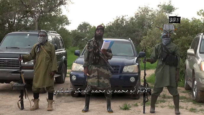 A screengrab taken on August 24, 2014 from a video released by the Nigerian Islamist extremist group Boko Haram and obtained by AFP shows the leader of the Nigerian Islamist extremist group Boko Haram, Abubakar Shekau (C), delivering a speech at an undisclosed location. (AFP Photo/Boko Haram)