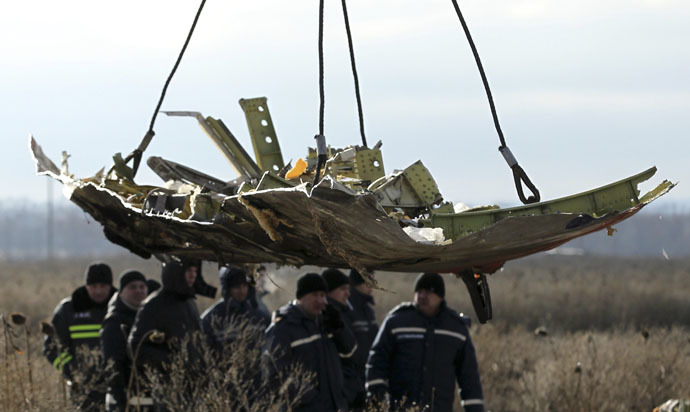 A crane transports a piece of the Malaysia Airlines flight MH17 wreckage at the site of the plane crash near the village of Hrabove (Grabovo) in Donetsk region, eastern Ukraine November 20, 2014. (Reuters/Antonio Bronic)