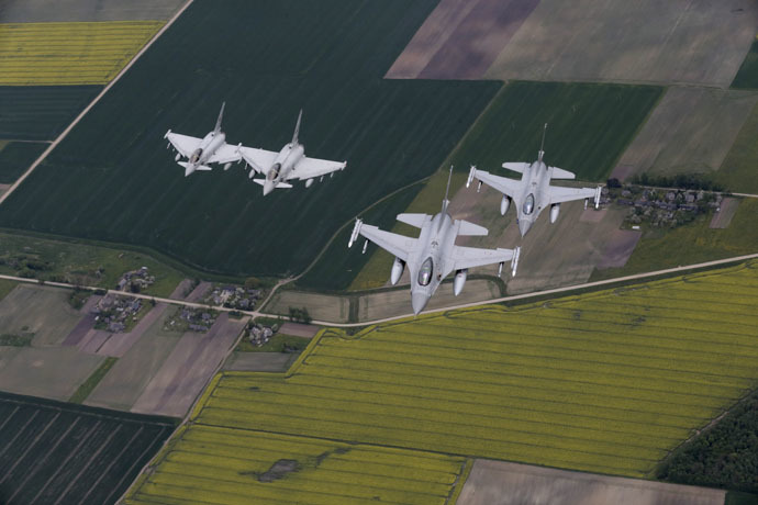 Norway's Air Force F-16 fighters (R) and Italy's Air Force Eurofighter Typhoon fighters patrol over the Baltics during a NATO air policing mission from Zokniai air base near Siauliai, Lithuania, May 20, 2015. (Reuters/Ints Kalnins)