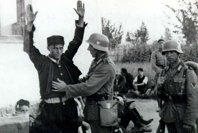 FILE PHOTO: Hitler's Wehrmacht soldier checks a Bosnian Moslem in Sarajevo in 1941 after Wehrmacht troops arrived in Bosnia. (Reuters)