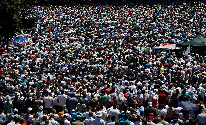 People attend a reburial ceremony of 136 newly identified victims in Potocari, near Srebrenica, Bosnia and Herzegovina July 11, 2015 (Reuters)