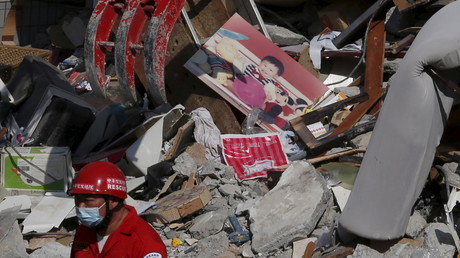 Une photo d'un enfant dans les décombre d'un bâtiment détruit