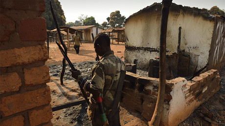 Un combattant anti-Balaka inspecte les ruines des bâtiments incendiés par des combattants de la Séléka en janvier 2014 , photo ©ERIC FEFERBERG / AFP