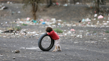 Un garçon se s'appuie sur un pneu dans un camp de fortune au Yémen (Illustration)