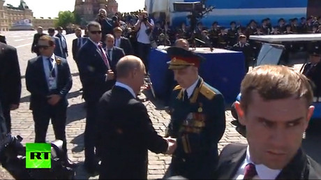 Le président russe Vladimir Poutine sert la main d'un vétéran de la Seconde guerre mondiale le 9 mai 2018 à Moscou.