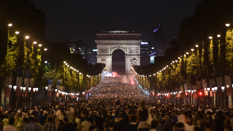 Les supporters célèbrent la victoire de la France devant l'Arc de Triomphe sur les Champs Elysées à Paris le 10 juillet 2018, après le coup de sifflet final du match de demi-finale de Coupe du Monde Russie 2018 entre la France et la Belgique.
