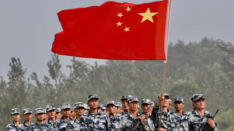 Des militaires chinois porte le drapeau national lors d'une cérémonie à Guangshui, dans la province du Hubei, le 30 juillet 2017.