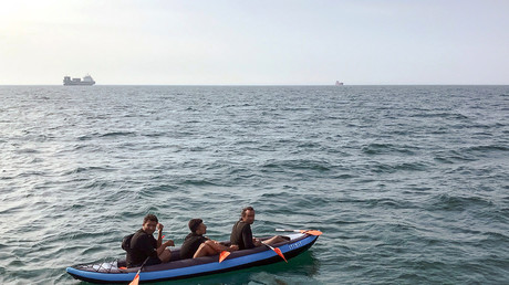 Trois migrants tenant de traverser la Manche depuis la France, au large des côtes de Calais en France, le 4 août 2018 (image d'illustration).  