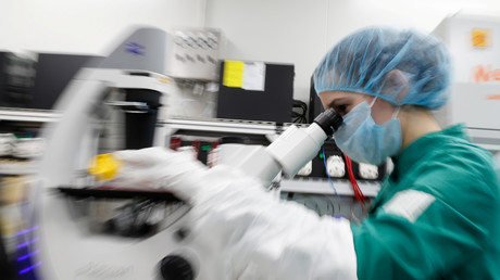 Un scientifique examine des cellules infectées par la COVID-19 au microscope lors d'une recherche d'un vaccin contre lecoronavirus dans un laboratoire de Saint-Pétersbourg