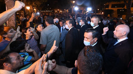 Le président tunisien Kaïs Saïed (à droite) saluant les Tunisiens alors qu'il se promène dans l'avenue centrale Habib-Bourguiba de Tunis, dans la nuit du 11 au 12 septembre 2021.