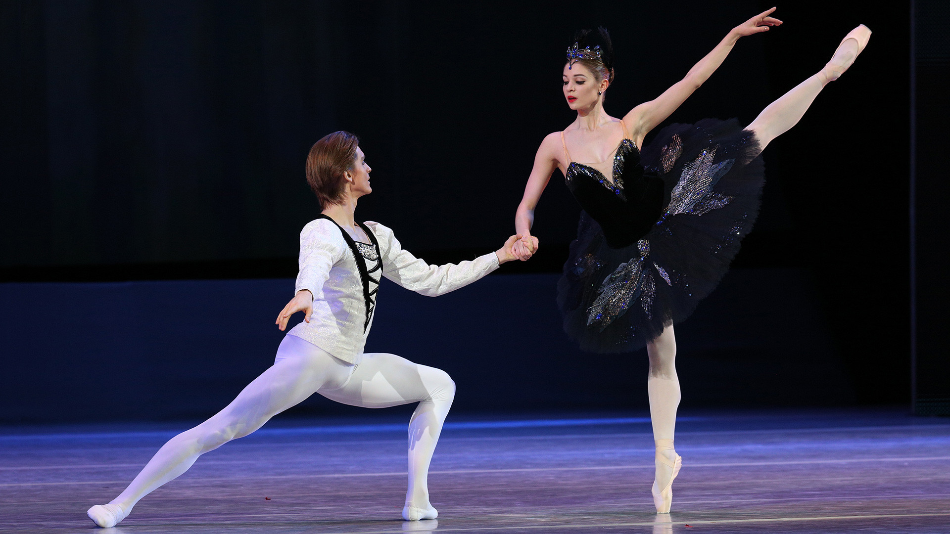 Angelina Vorontsova and Denis Rodkin performing a piece from Swan Lake on the stage of The State Kremlin Palace.