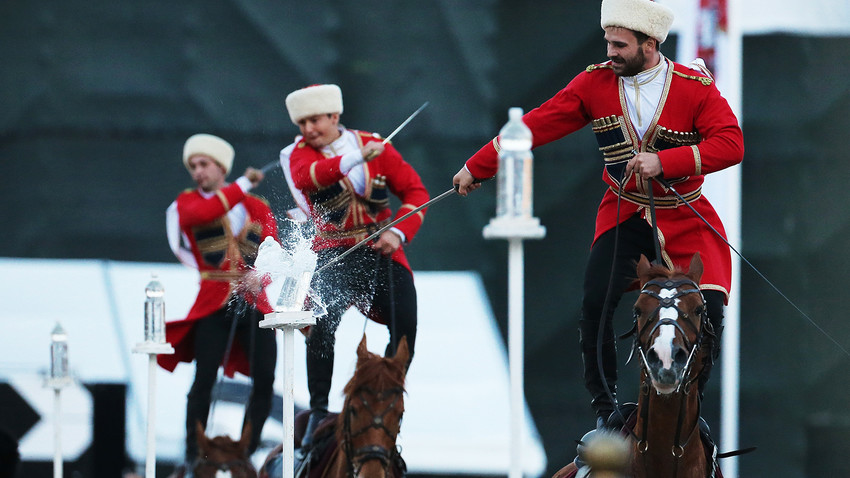The Cavalry Escort of the Presidential Regiment and the Kremlin Equestrian School performs trick riding on Red Square during the 2016 Military Music Festival "Spasskaya Tower".
