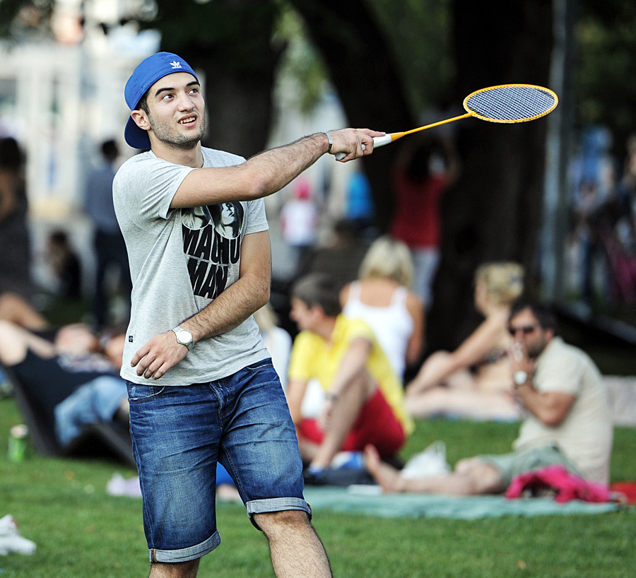 A young man enjoys badminton in a Moscow park