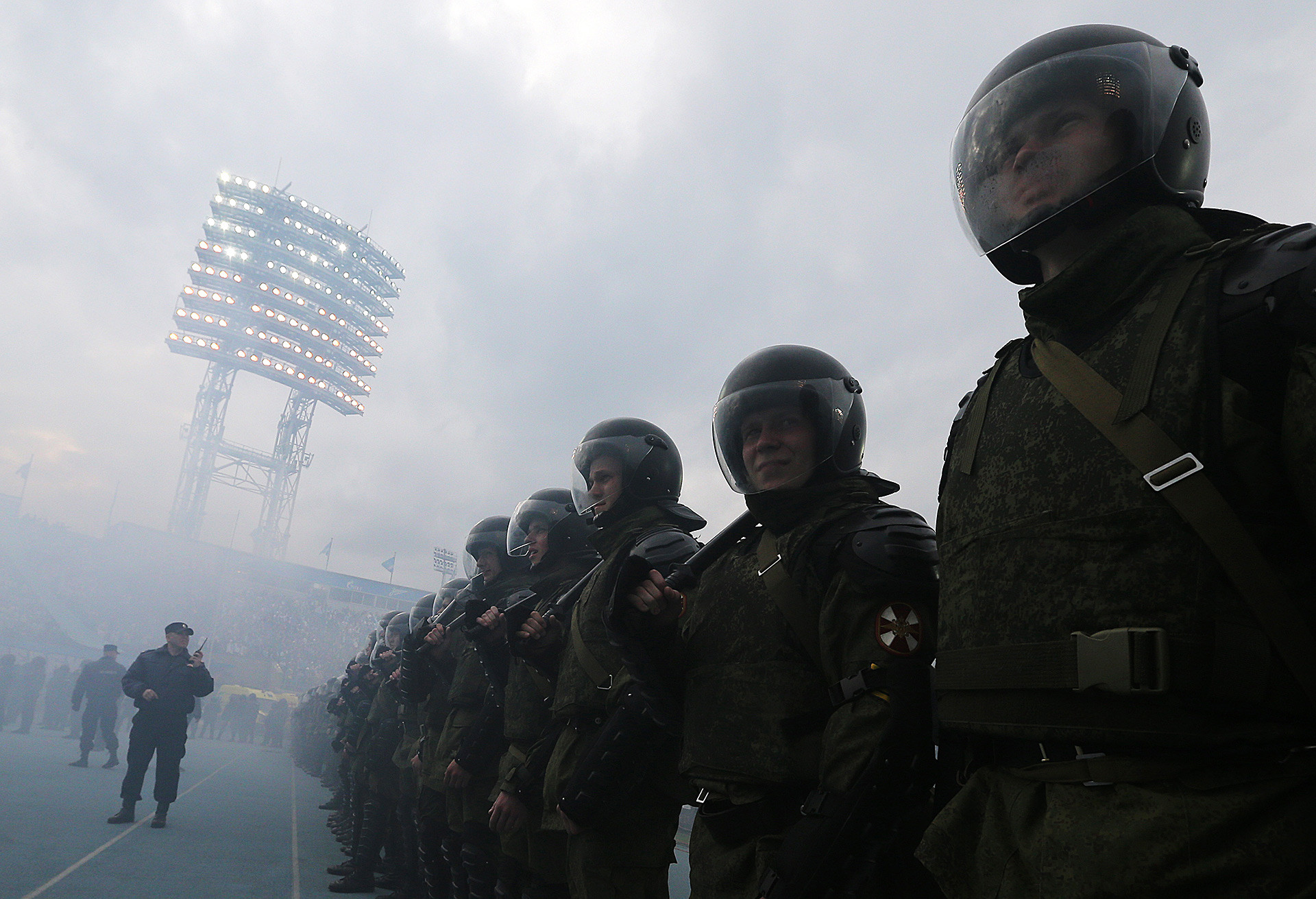Police officers seen as football fans set off flares after the 2014/15 Season Russian Premier League.
