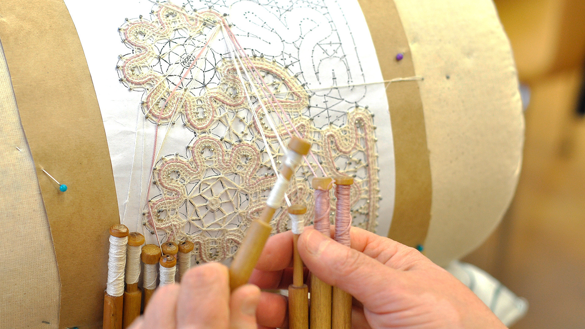 Vologda lace is entirely handmade with wooden bobbins.