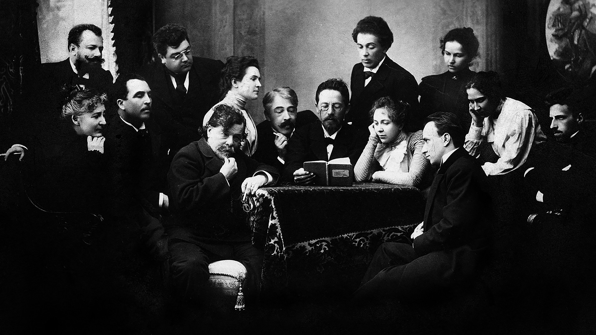 Chekhov reading 'The Seagull' to a group of actors of the Moscow Art Theater; among them are Konstantin Stanislavsky (left from Chekhov), Olga Knipper (second left from Chekhov), Vsevolod Meyerhold (right), and Vladimir Nemirovich Danchenko (stands left)
