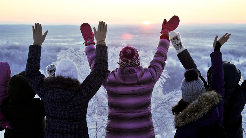 People welcome the sun rising over Murmansk for the first time since early December 2017 and marking the end of a polar night