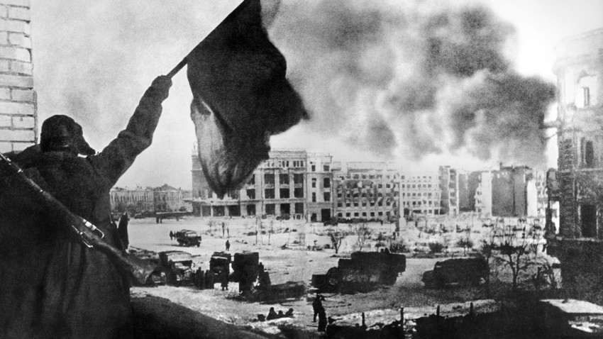 Soviet soldier waving the Red Banner over the central plaza of Stalingrad