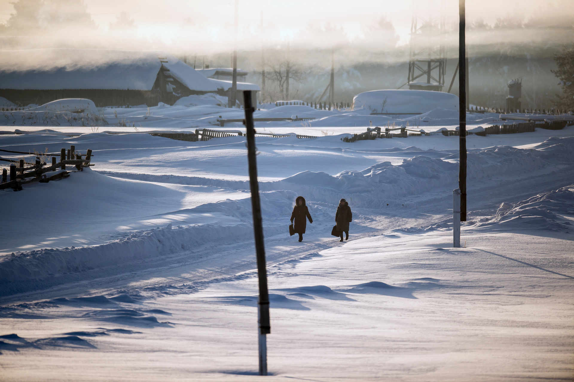 Villagers walk in the street in Yegorovka. Omsk region, Russia