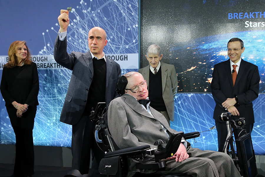 Yuri Milner holds up a prototype of the 'Star Chip', a small robotic space craft that will enable intersteller space travel as he poses with Professor Stephen Hawking.