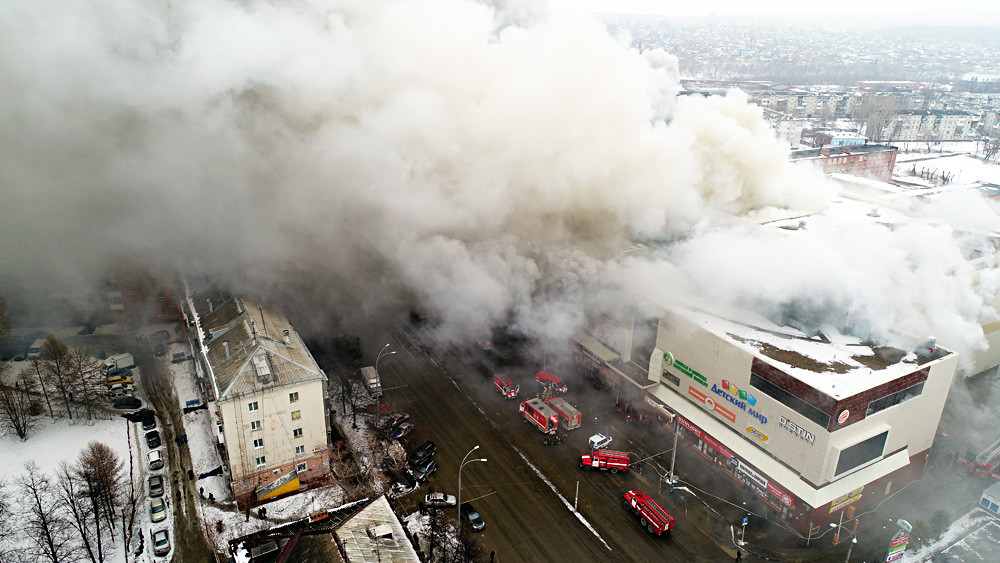 Smoke rises above a multi-story shopping center in the Siberian city of Kemerovo on March 25, 2018. 