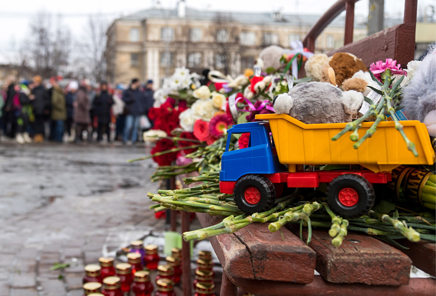 Flowers, candles and toys outside the Zimnyaya Vishnya shopping center where at least 64 people died in the fire.